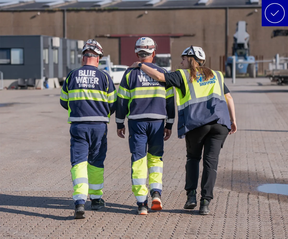 Blue Water colleagues walking together outside a warehouse building.